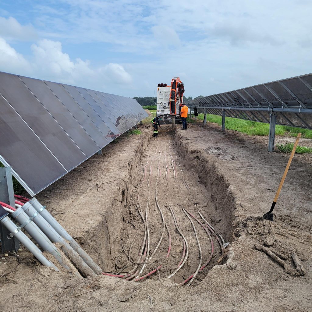 Ox OnSite truck digging underground utilities in a solar farm